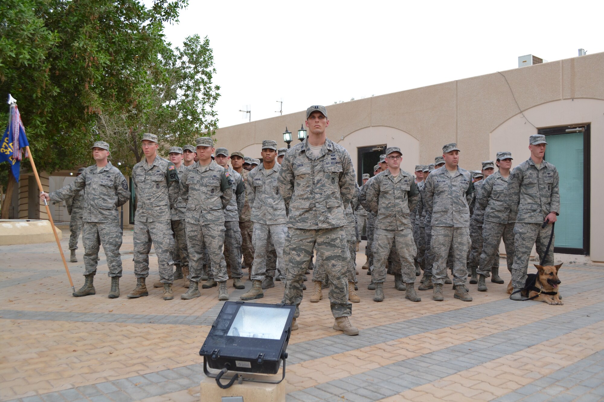 Members of the 64th Expeditionary Security Forces Squadron stand at parade rest during the retreat ceremony as part of the Police Week activities at Eskan Village in Southwest Asia, May 15, 2013. (U.S. Air Force photo/Staff Sgt. Jason Colbert)