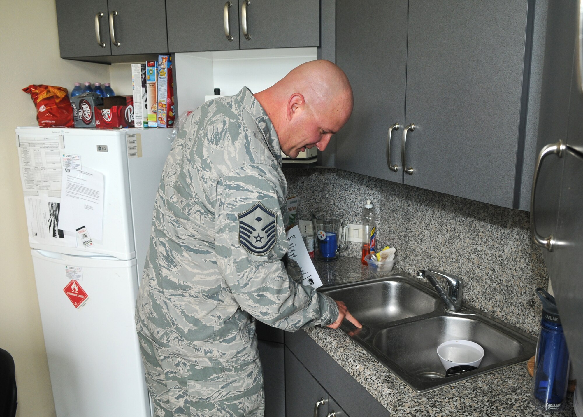 Master Sgt. Steven Mountz, 31st Comptroller Squadron first sergeant, inspects a dormitory room May 22, 2013 at Aviano Air Base, Italy. Group commanders, squadron commanders, first sergeants or designated representatives may conduct no-notice inspections at any given time. (U.S. Air Force photo/Airman Ryan Conroy) 