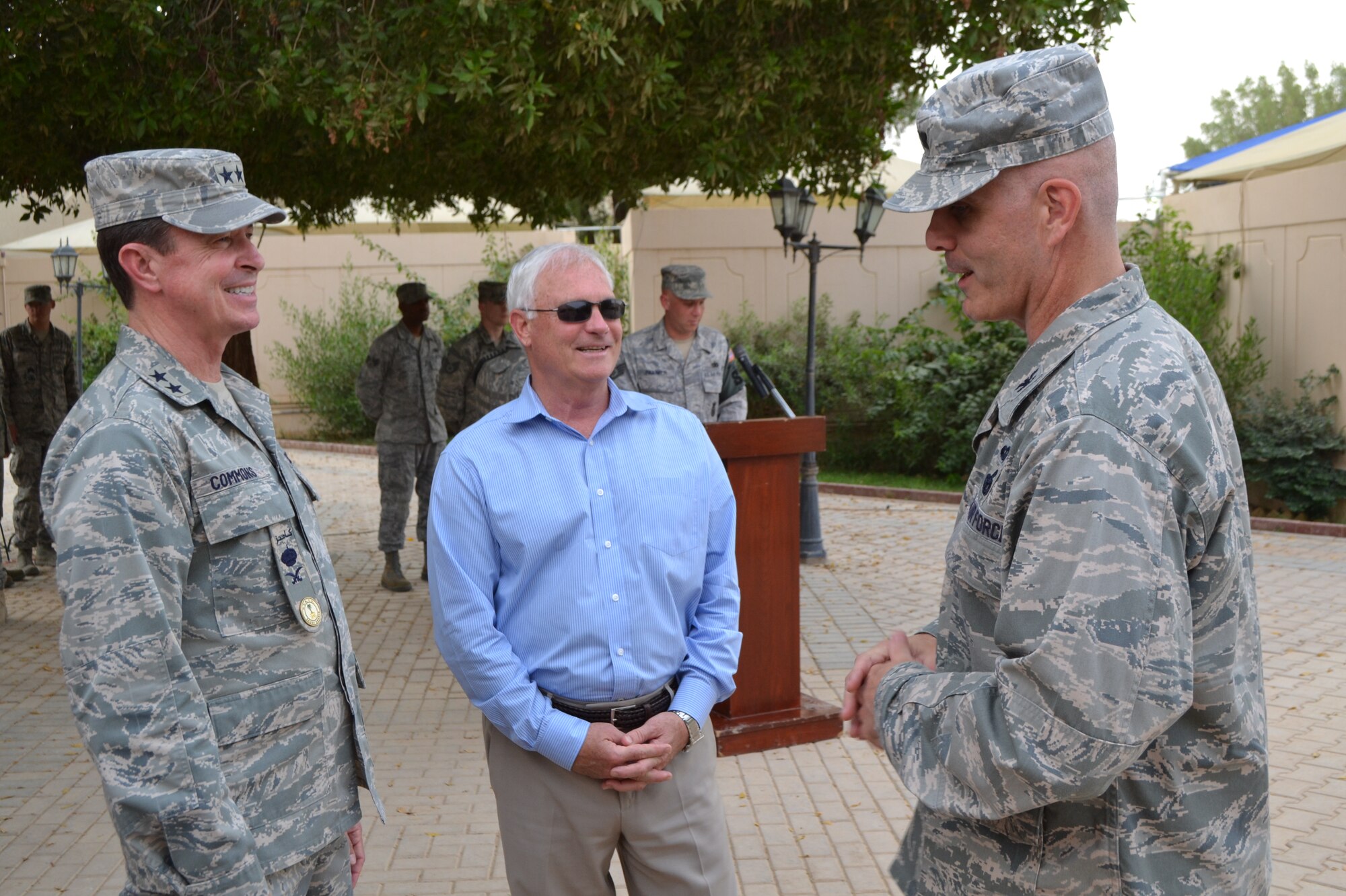 Maj. Gen. David Commons, United States Military Training Mission chief, Jackie Mathis, USMTM chief of staff, and Col. Michael Florio, 64th Air Expeditionary Group commander, speak before the start of the retreat ceremony during the Police Week activities at Eskan Village in Southwest Asia, May 15, 2013. (U.S. Air Force photo/Staff Sgt. Jason Colbert)