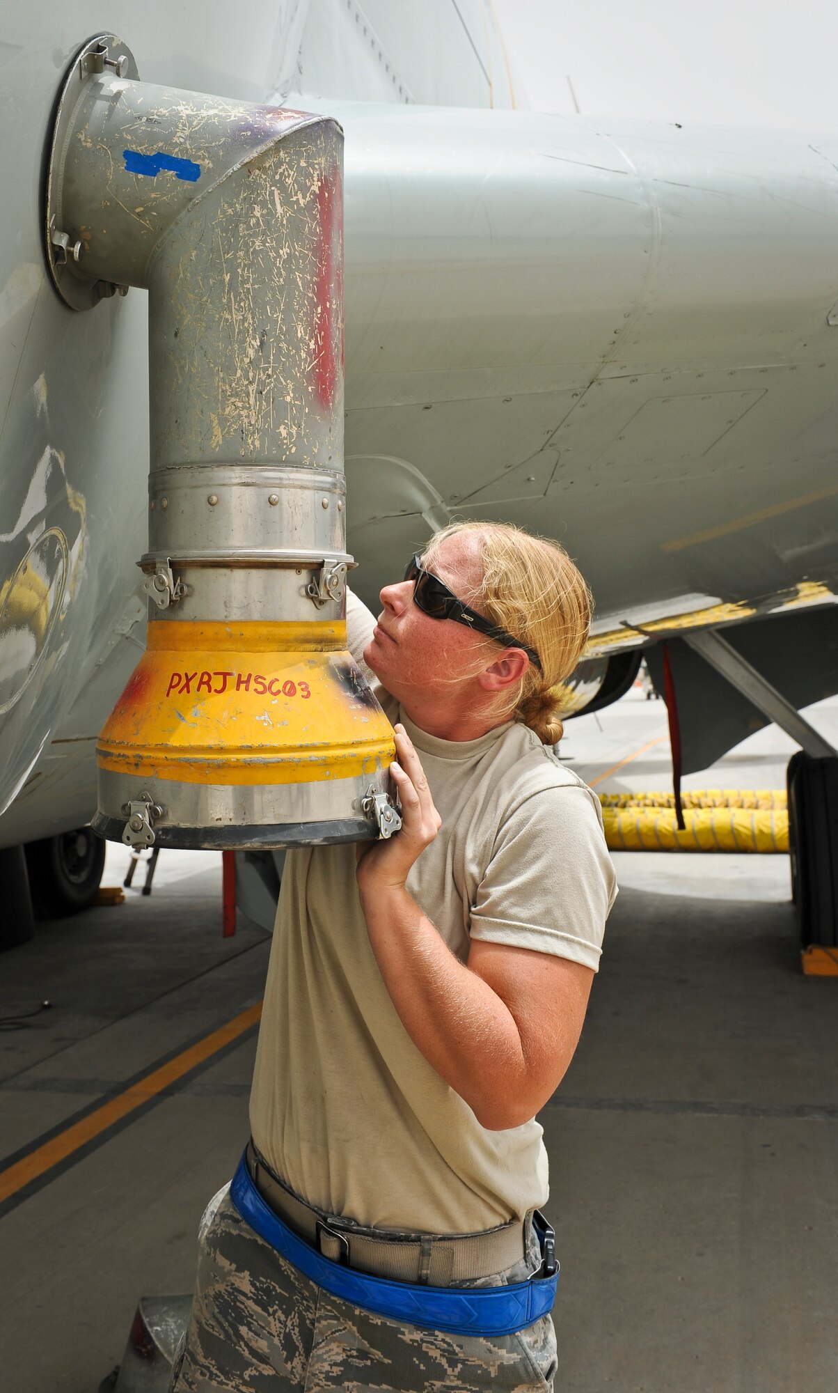 Staff Sgt. Stephanie Wang connects an air conditioning tube attachment to a recently arrived RC-135 Rivet Joint May 22, 2013, at the 379th Air Expeditionary Wing in Southwest Asia. Wang is a 763rd Aircraft Maintenance Unit electrician deployed from Offutt Air Force Base, Neb. (U.S. Air Force photo/Senior Airman Benjamin Stratton)