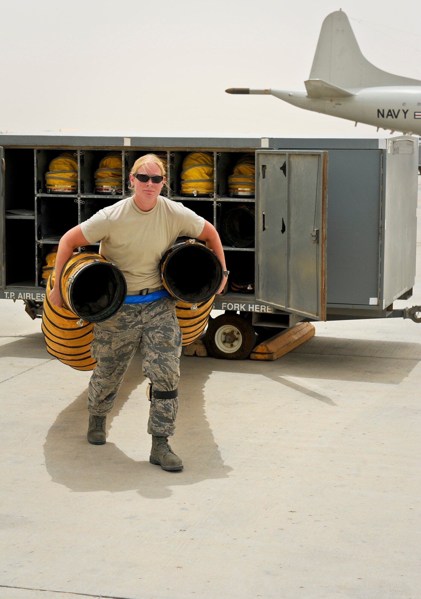 Staff Sgt. Stephanie Wang pulls air conditioning tubes from their racks to a recently arrived RC-135 Rivet Joint May 22, 2013, at the 379th Air Expeditionary Wing in Southwest Asia. Wang is a 763rd Aircraft Maintenance Unit electrician deployed from Offutt Air Force Base, Neb. (U.S. Air Force photo/Senior Airman Benjamin Stratton)