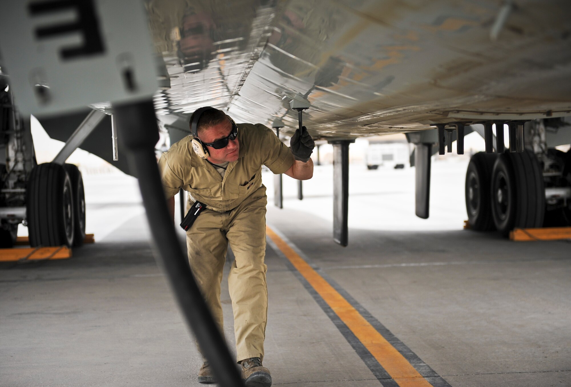 Staff Sgt. Jeffery DeHaan completes post-flight maintenance checks for a recently arrived RC-135 Rivet Joint May 22, 2013, at the 379th Air Expeditionary Wing in Southwest Asia. Brushel is a 763rd Aircraft Maintenance Unit crew chief deployed from Offutt Air Force Base, Neb. (U.S. Air Force photo/Senior Airman Benjamin Stratton)