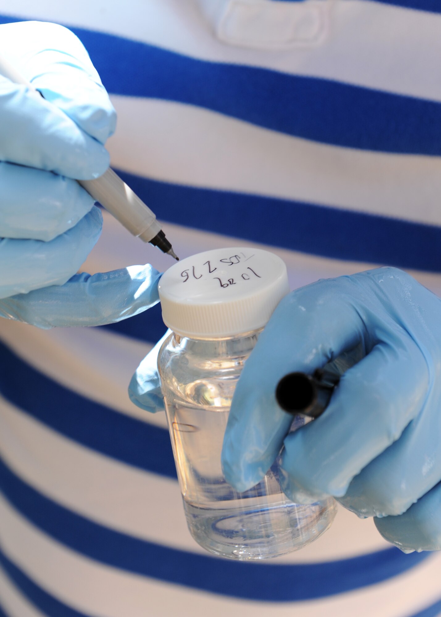 Staff Sgt. Henry Lux, 39th Medical Operations Squadron bioenvironmental engineer, marks a water sample from Gaziantep, Turkey, for future incubation May 20, 2013. Incubation helps to determine if any biological agents contaminate the water supply. (U.S. Air Force photo/Senior Airman Chase Hedrick/Released)