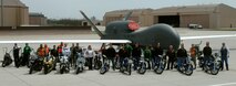 Motorcycle Rally and Safety Fair participants take advantage of a unique opportunity to have their photo taken on the base flight line with a Global Hawk at Grand Forks Air Force Base, N.D., on May 17, 2013. The 319th Safety Office hosted a safety standdown day that concentrated on the importance of making smart choices on the road, on the water, and on vacation. (U.S. Air Force photo/Staff Sgt. Susan L. Davis)