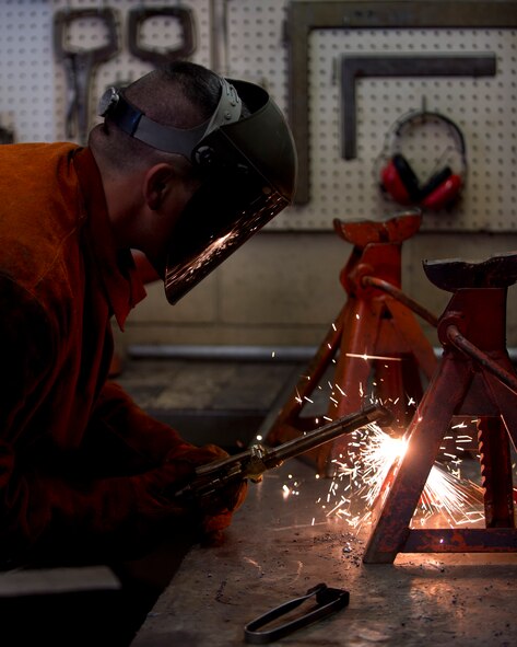 Master Sgt. Louis Dutra, 133rd Logistics Readiness Squadron, Vehicle Maintenance Flight, uses a cutting torch to cut a non-serviceable jack stand in St. Paul, Minn., May 16, 2013. Dutra worked while being inspected by a member of the Logistics Compliance Assistance Program team. 
(U.S. Air Force photo by Tech. Sgt. Amy M. Lovgren/Released)
