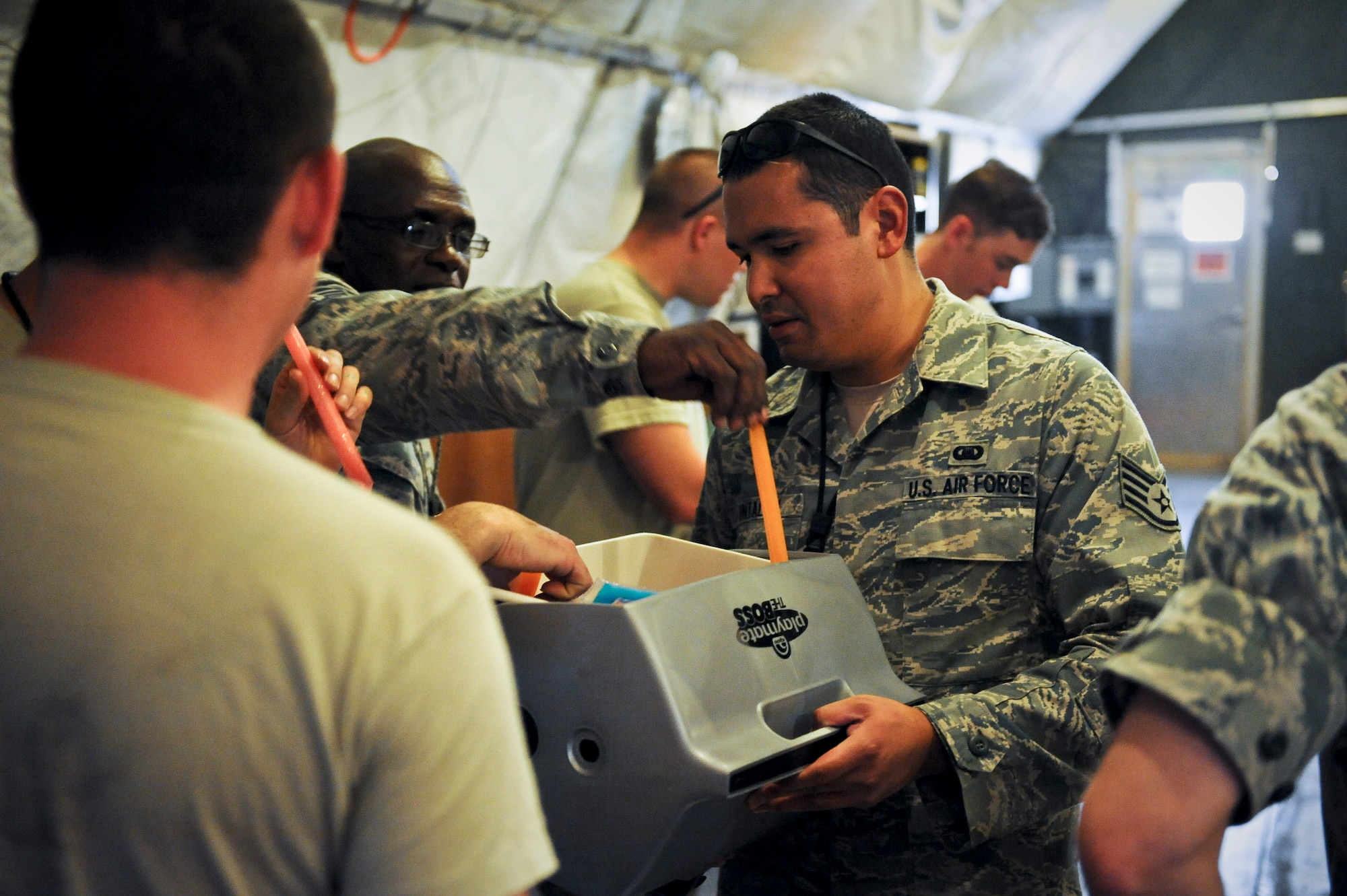 Staff Sgt. Bernard Untalan hands out popsicles to Airmen from the 379th Expeditionary Aircraft Maintenance Squadron, providing a refreshment and spiritual readiness May 16, 2013, at the 379th Air Expeditionary Wing in Southwest Asia. Untalan was Chaplain (Capt.) David Dziolek’s chaplain assistant during their tenure at the 379th. (U.S. Air Force photo/Senior Airman Benjamin Stratton)