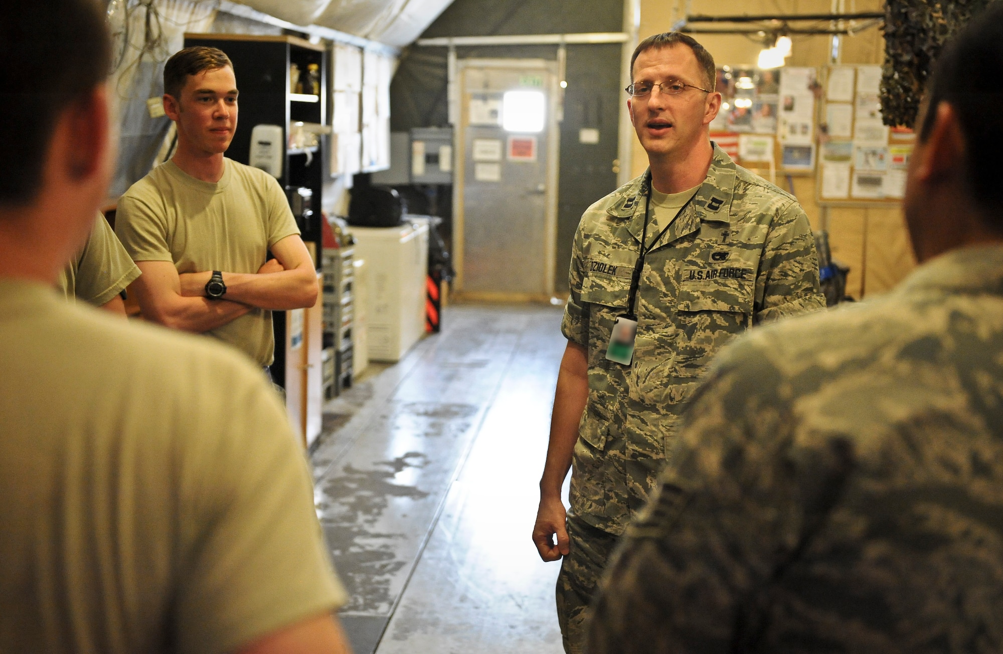 Chaplain (Capt.) David Dziolek visits with Airmen from the 379th Expeditionary Aircraft Maintenance Squadron, providing spiritual readiness May 16, 2013, at the 379th Air Expeditionary Wing in Southwest Asia. The chaplain began his career as an enlisted F-15E Strike Eagle mechanic. (U.S. Air Force photo/Senior Airman Benjamin Stratton)