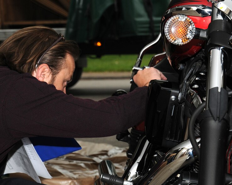 Donald Fox, 100th Logistics Readiness Squadron Quality Assurance inspector from Three Oaks, Mich., inspects a motorcycle belonging to Chief Master Sgt. Randy Ymker, 100th Mission Support Group superintendent from Kay Warden, Iowa, May 22, 2013, at Ymker’s residence near RAF Mildenhall, England. Ymker’s outdoor belongings received a High-Risk Agricultural Inspection prior to his household goods being collected. (U.S. Air Force photo by Gina Randall/Released)