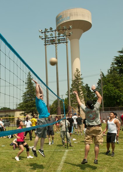 YOKOTA AIR BASE, Japan -- An Airman leaps in the air to spike a volleyball during Airmen Appreciation Day at Yokota Air Base, Japan, May 23, 2013. Other events included flag football, sumo wrestling, dodgeball, bingo, a dunk tank, battle buddy challenge and more. (U.S. Air Force photo by Senior Airman Michael Washburn/Released)