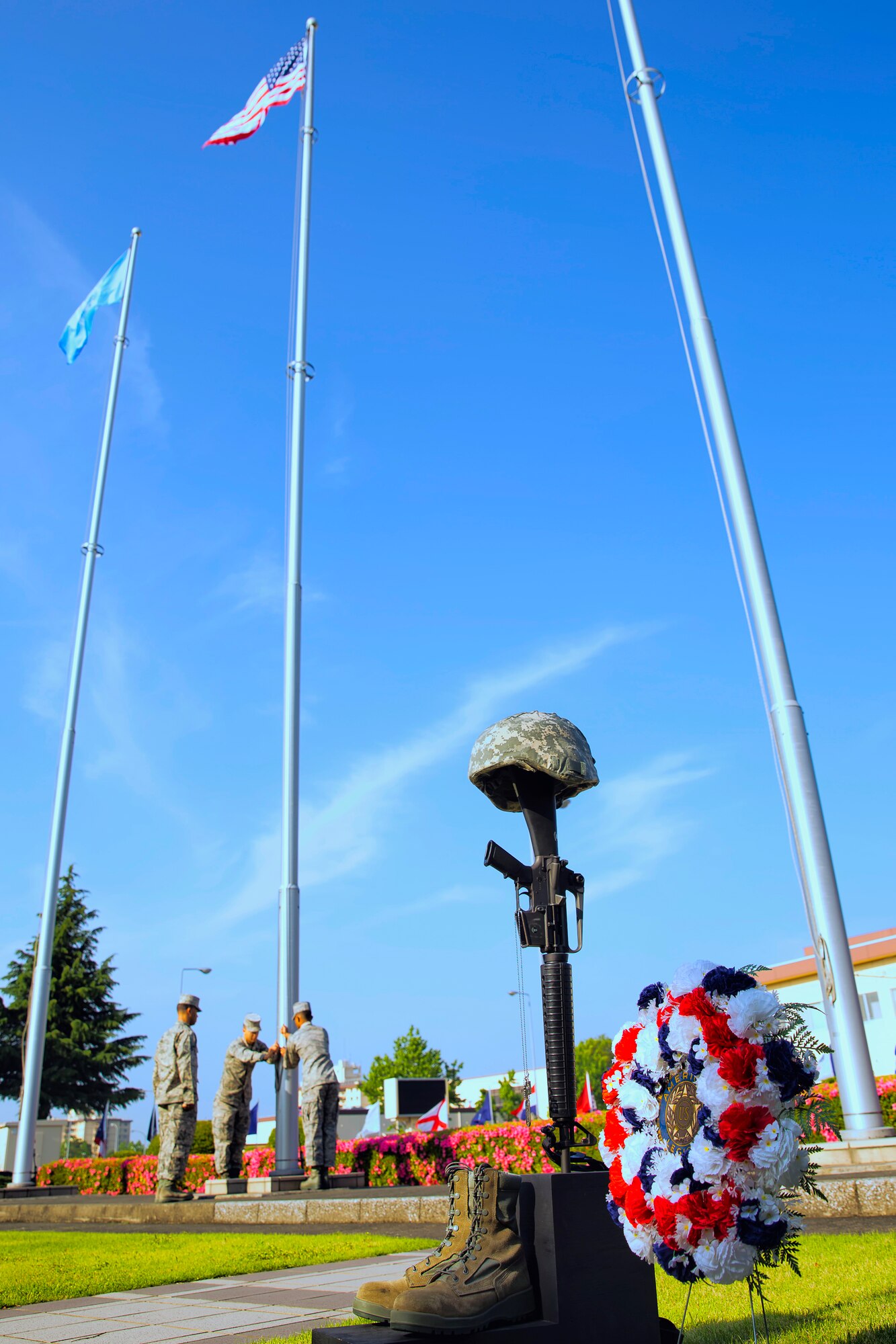 YOKOTA AIR BASE, Japan -- Members of the Yokota Honor Guard secure the American flag during the Memorial Day ceremony at the 374th Airlift Wing headquarters building on Yokota Air Base, Japan, May 23, 2013. Memorial Day commemorates the men and women of the armed forces who have given the ultimate sacrifice while in military service. (U.S. Air Force photo by Osakabe Yasuo) 