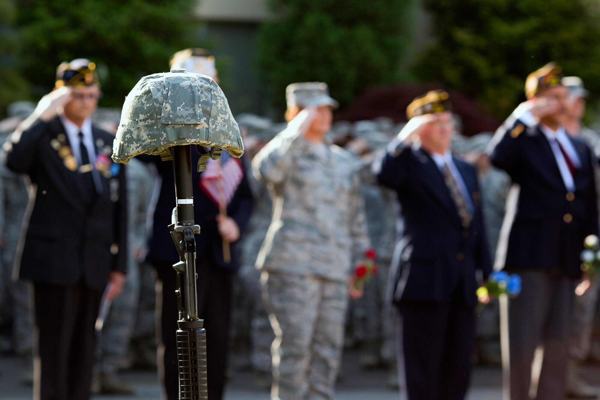 YOKOTA AIR BASE, Japan -- Airmen and Veterans salute during the Memorial Day ceremony at the 374th Airlift Wing headquarters building on Yokota Air Base, Japan, May 23, 2013. The 374th Airlift Wing held the ceremony in memory of those who have given the ultimate sacrifice while in military service. (U.S. Air Force photo by Osakabe Yasuo)