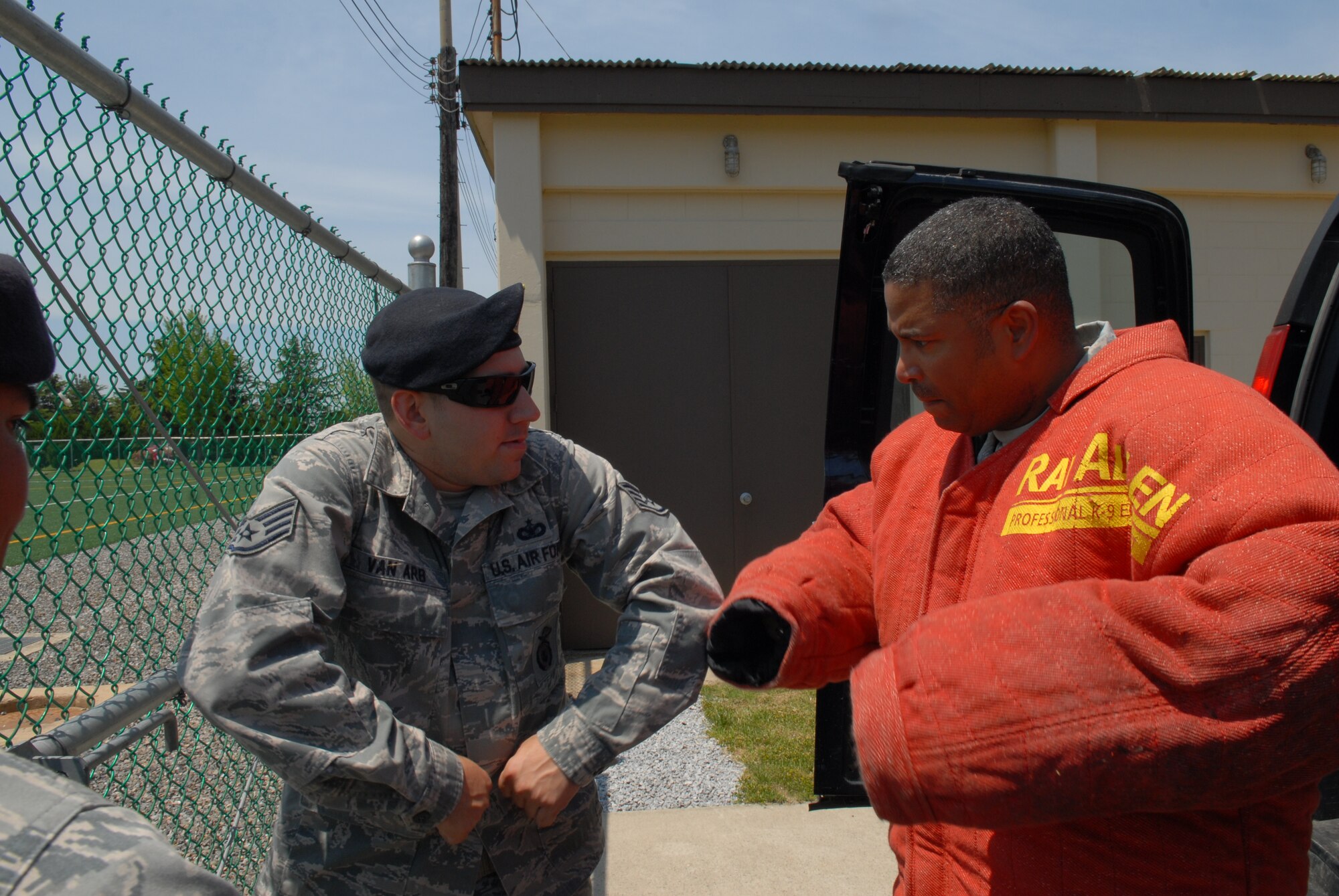 KUNSAN AIR BASE, Republic of Korea – Chief Master Sgt. Phillip Robinson, 8th Fighter Wing command chief receives instructions from Staff Sgt. Andrew Van Arb, 8th Security Forces Squadron member prior to a military-working-dog demonstration at the base soccer field, May 14, 2013. Robinson wore a K-9 bite suit for protection, and learned the proper body positions to minimize injuries. (U.S. Air Force photo by Staff Sgt. Tong  Duong/ Released)