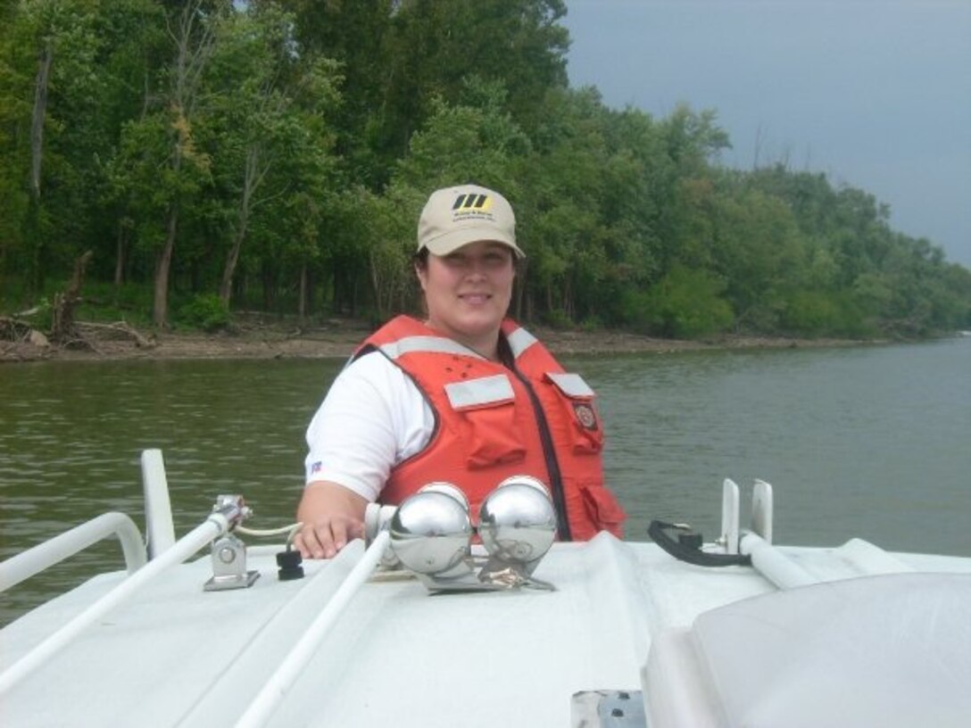 Jade Young, Louisville District, U.S. Army Corps of Engineers biologist, rides on the sampling boat while gathering samples to test water quality.