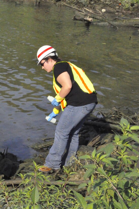 Jade Young, Louisville District, U.S. Army Corps of Engineers biologist, gathers samples for testing water quality.