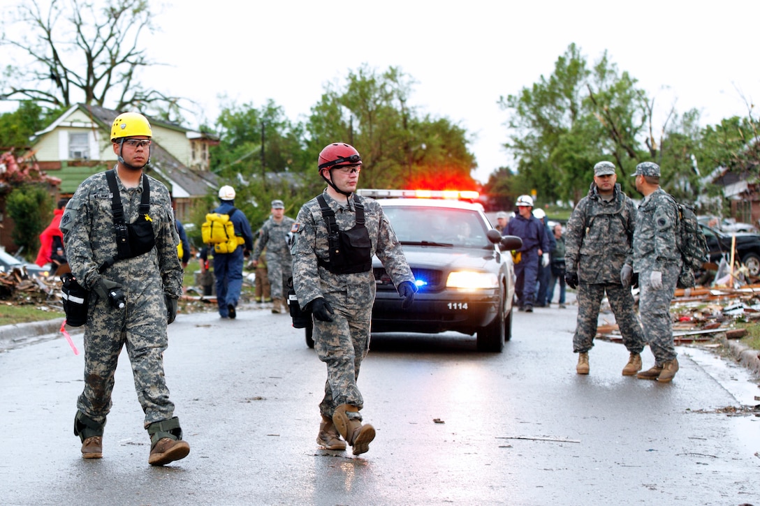 Oklahoma National Guardsmen conduct search and rescue operations in Moore, Okla., May 21, 2013, after a devastating tornado killed dozens of people there, May 20. The guardsmen are assigned to the 63rd Civil Support Team.
