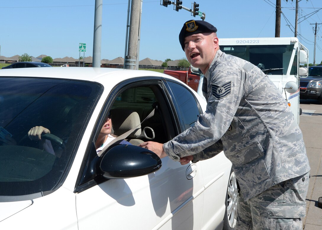 Air Force Tech. Sgt. Tyler Florence, right, directs traffic in a tornado stricken area in Moore, Okla., May 22, 2013, after a devastating tornado killed dozens of people there, May 20. Florence is assigned to the 138th Fighter Wing Security Forces.