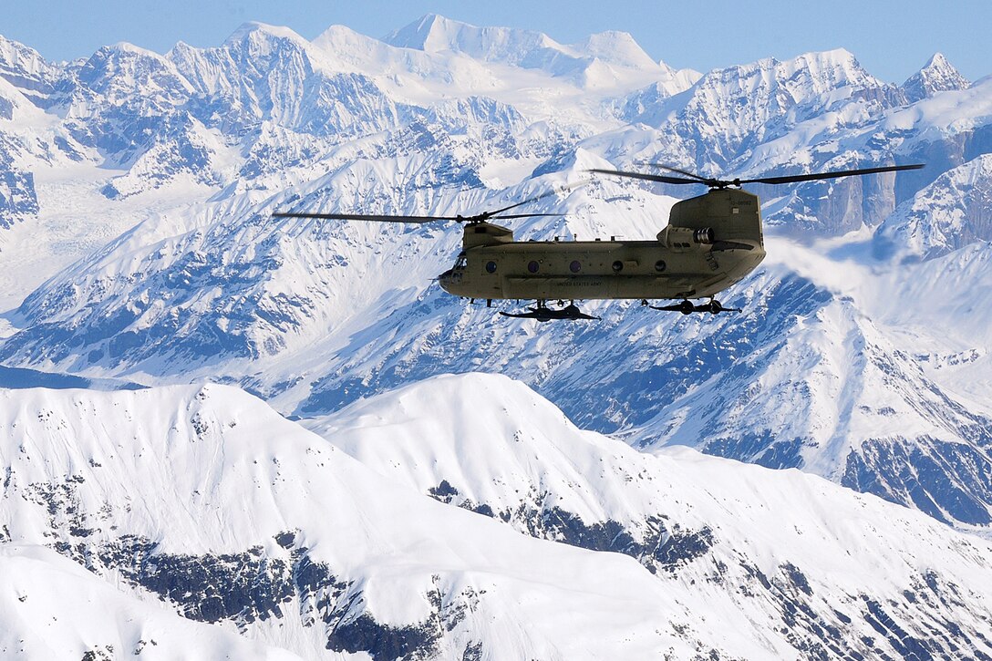 A CH-47 Chinook helicopter flies along the Alaska Range on its way to Kahiltna Glacier, Alaska, May 20, 2013. Helicopter crew members, assigned to Company B, 1st Battalion, 52nd Aviation Regiment, transported eight soldiers and one Army civilian from Fort Wainwright to the National Park Service base camp on the glacier to begin their attempt to climb Mount McKinley, North America's tallest peak. The climbers are assigned to U.S. Army Alaska's Northern Warfare Training Center and the 25th Infantry Division's 1st Stryker Brigade Combat Team.