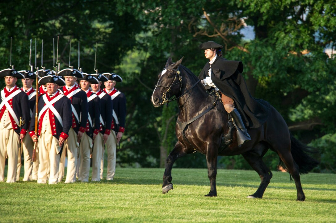 Soldiers assigned to the 3rd Infantry Regiment, also known as "The Old Guard," perform during the Twilight Tattoo on Joint Base Myer-Henderson Hall, Va., May 22, 2013.