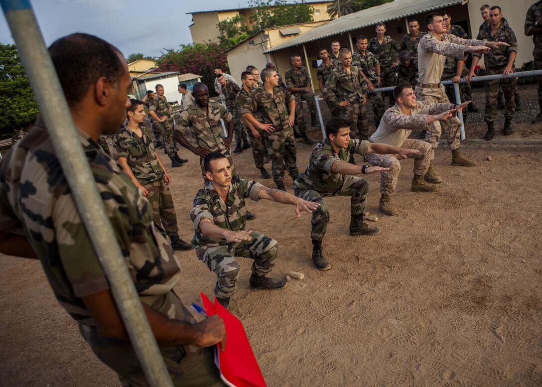 U.S. Marines assigned to 26th Marine Expeditionary Unit (MEU), perform squats during a physical endurance test with French Marines assigned to 110th Infantry Regiment, French and German Brigade, aboard General Briere de L'Isle Base in Djibouti, Africa, May 22, 2013. The physical endurance test was a portion of the screening for the French Marine's Desert Survival Combat Course, a 10-day bilateral training event that teaches participants how to survive in the desert. The 26th MEU is deployed to the 5th Fleet area of operations as part of the Kearsarge Amphibious Ready Group. The 26th MEU operates continuously across the globe, providing the president and unified combatant commanders with a forward-deployed, sea-based quick reaction force. (U.S. Marine Corps photo by Sergeant Christopher Q. Stone, 26th MEU Combat Camera/Released)