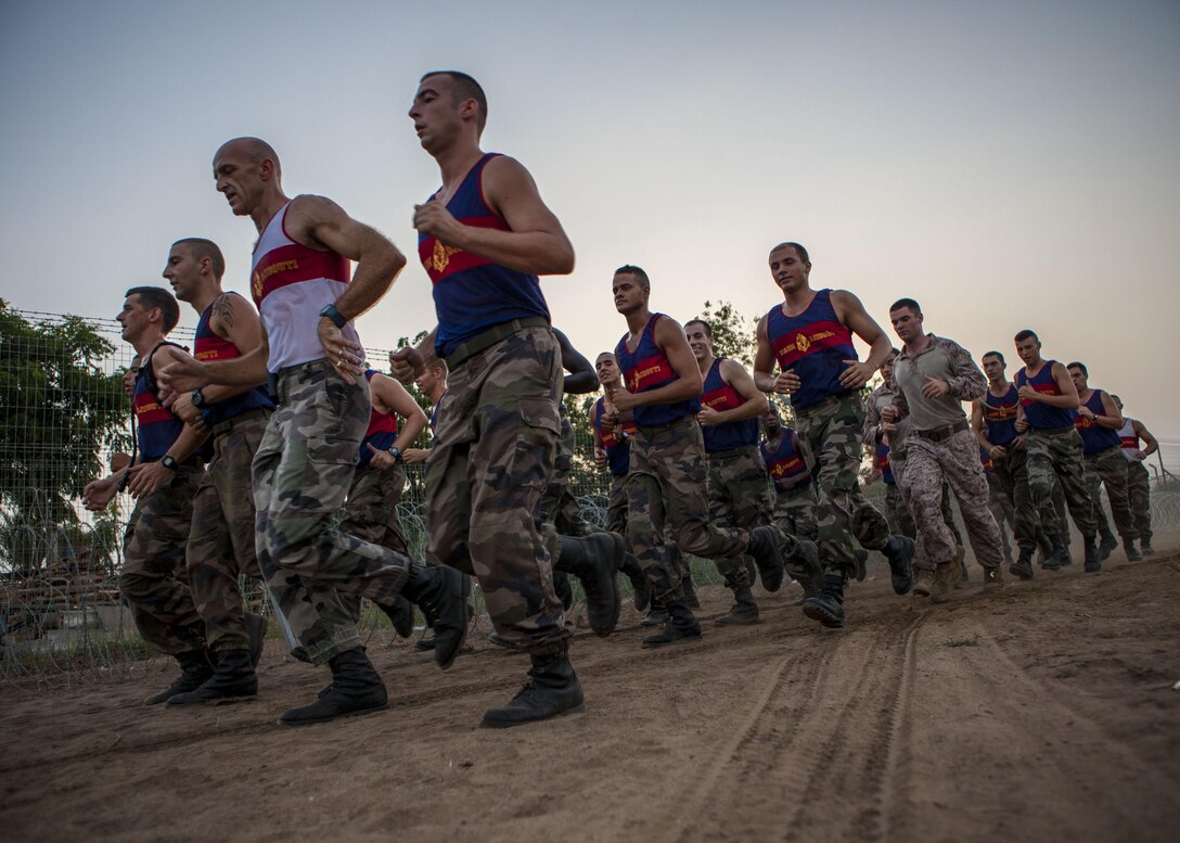 U.S. Marines assigned to 26th Marine Expeditionary Unit (MEU), conduct an 8km formation run with French Marines assigned to 110th Infantry Regiment, French and German Brigade, aboard General Briere de L'Isle Base in Djibouti, Africa, May 23, 2013. The formation run was a portion of the screening for the French Marine's Desert Survival Combat Course, a 10-day bilateral training event that teaches participants how to survive in the desert. The 26th MEU is deployed to the 5th Fleet area of operations as part of the Kearsarge Amphibious Ready Group. The 26th MEU operates continuously across the globe, providing the president and unified combatant commanders with a forward-deployed, sea-based quick reaction force. (U.S. Marine Corps photo by Sergeant Christopher Q. Stone, 26th MEU Combat Camera/Released)