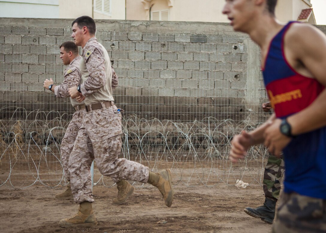 U.S. Marines assigned to 26th Marine Expeditionary Unit (MEU), conduct an 8km formation run with French Marines assigned to 110th Infantry Regiment, French and German Brigade, aboard General Briere de L'Isle Base in Djibouti, Africa, May 23, 2013. The formation run was a portion of the screening for the French Marine's Desert Survival Combat Course, a 10-day bilateral training event that teaches participants how to survive in the desert. The 26th MEU is deployed to the 5th Fleet area of operations as part of the Kearsarge Amphibious Ready Group. The 26th MEU operates continuously across the globe, providing the president and unified combatant commanders with a forward-deployed, sea-based quick reaction force. (U.S. Marine Corps photo by Sergeant Christopher Q. Stone, 26th MEU Combat Camera/Released)