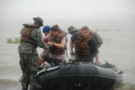 Louisiana Army National Guardsmen from the 2225th Multi-Role Bridge Company in Marrero, La., bring residents of Hackberry, La., to dry land after the small town in the southwest portion of the state received massive flooding caused by Hurricane Ike. Soldiers from the company have been assigned to the area to offer assistance to the Department of Wildlife and Fisheries in search and rescue missions.