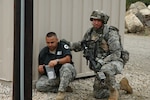 A Massachusetts Army National Guard Soldier trains in urban warfare techniques at the Military Operations on Urban Terrain Site at Camp Edwards in Massachusetts. The MOUT site is one of the new facilities at the Cape Cod post.