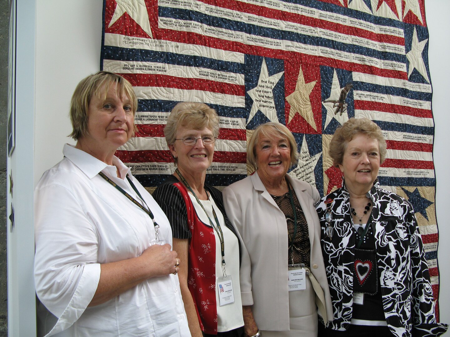(Left to right) Donna J. Birtwistle, Mavis Olsen, Marlene Wallace and Penny Eakin stand before their patchwork quilt at the Women in Military Service for America Memorial, Sept. 17, 2008. The quilt honors military women who've died during the global war on terrorism.