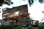 A U.S. flag flies, covered in mud and debris, in front of the Cameron, La., court house Sept. 15. The flag was rescued by members of the Louisiana Army National Guard's 528th Engineer Battalion who were performing cleanup operations in the city.