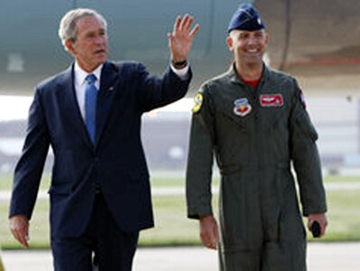 President George Bush talks with Air Force Maj. Dan Rooney of the Oklahoma Air National Guard after arriving at Tinker Air Force Base, Okla., Sept. 12, 2008. Bush presented Rooney with the President's Volunteer Service Award for his contributions to the lives of military families through his Folds of Honor Foundation. Rooney left for his third tour in Iraq shortly after receiving the award.