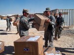 Virginia National Guard Spc. Phillip Read and other Soldiers receive kits that contain an egg crate mattress pad, a set of sheets and a pillow sent from the "Sleep for Soldiers" initiative.