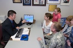 Wisconsin National Guard transition assistance advisor Jeff Unger counsels Capt. Dan Hanson, his wife Jen, and their children Mitch, Jake, and Liz, at his office in Madison, April 4, 2007.