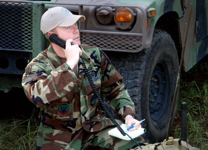 Air Force Senior Airman Gabe Bird provides satellite radio communications for the Cameron Emergency Operations Center damage assessment team in Cameron, La., during the response to Hurricane Ike. Bird is a joint tactical air controller with the Louisiana Air National Guard's 122nd Air Support Operations Squadron at Camp Beauregard, La.