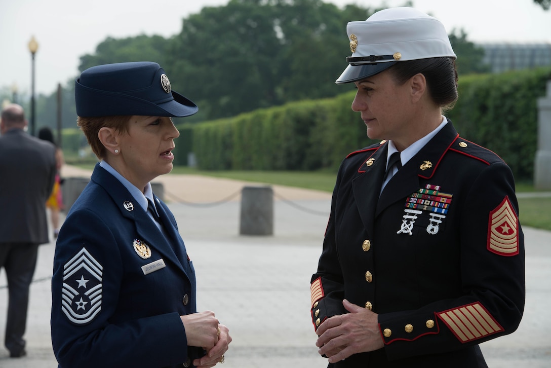Chief Master Sgt. Denise Jelinski-Hall, left, Senior Enlisted Leader for the National Guard Bureau, speaks to Sgt. Maj. Angela Maness, right, soon to be sergeant major of Marine Barracks Washington, at the Women in the Military Wreath Laying Ceremony, May 22. 