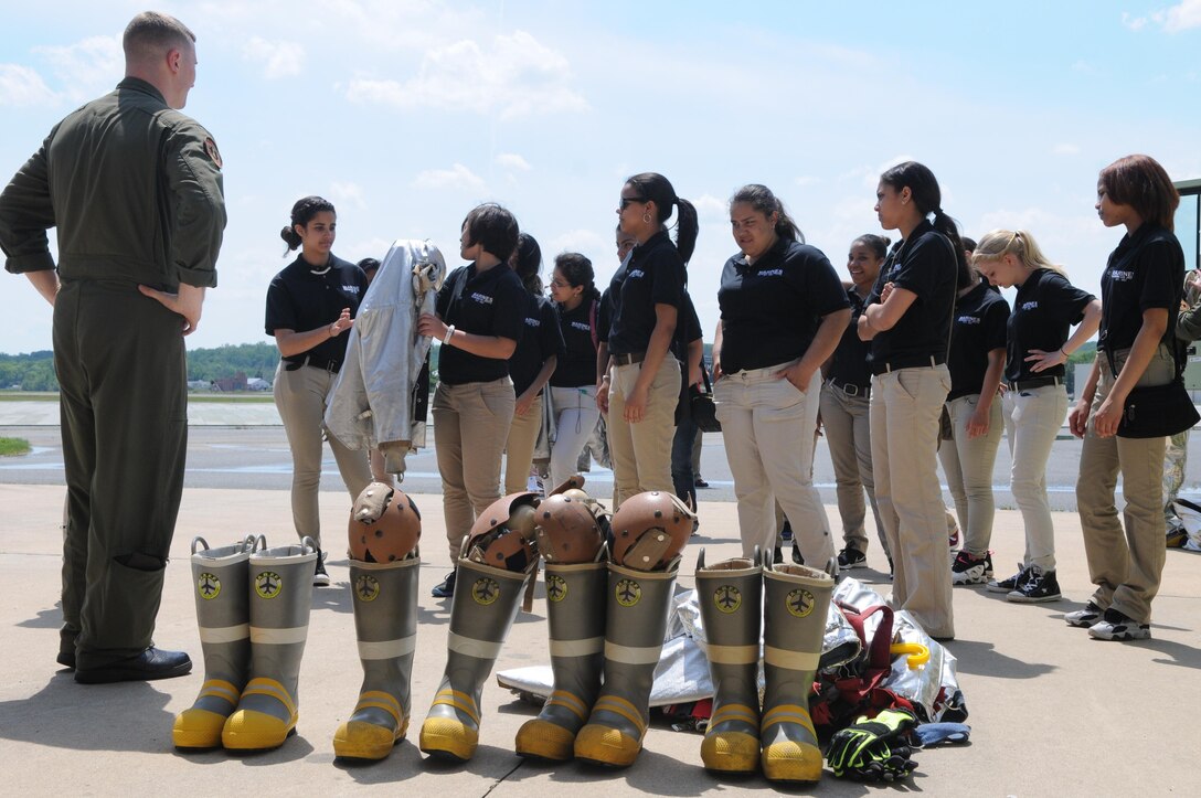 Cpl. Michael Melson of Marine Corps Air Facility Quantico’s Aircraft Rescue Firefighter unit looks on as members of Reading High School’s Marine Corps JROTC check out firefighting gear during a demonstration at the fire station May 10, 2013. 