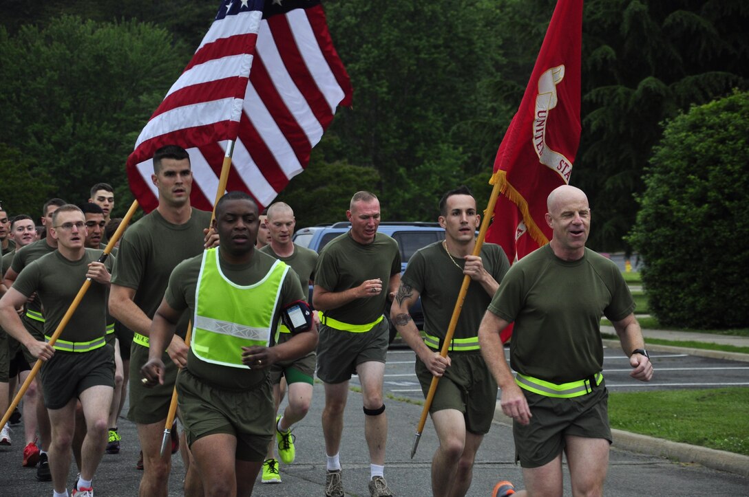 Col. James Brennan, right, Headquarters and Service Battalion commanding officer, and Sgt. Maj. Michael Moore, H&S Bn. sergeant major, lead H&S Bn. Marines in a pre-Memorial Day run May 24, 2013. The Marines ran a three-milelong circuit aboard Marine Corps Base Quantico. H&S Bn. is comprised of Headquarters Company, Combat Development Co., Service Co., Tenant Activities Co. and Training and Education Co.