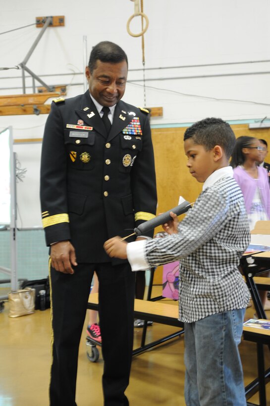 Russell Elementary School second-grader Dushawn demonstrates his slingshot rocket for Lt. Gen. Thomas P. Bostick, commanding general of the U.S. Army Corps of Engineers, during an event announcing a partnership between USACE and Department of Defense Education Activity at Ashurst Elementary May 20, 2013. 
