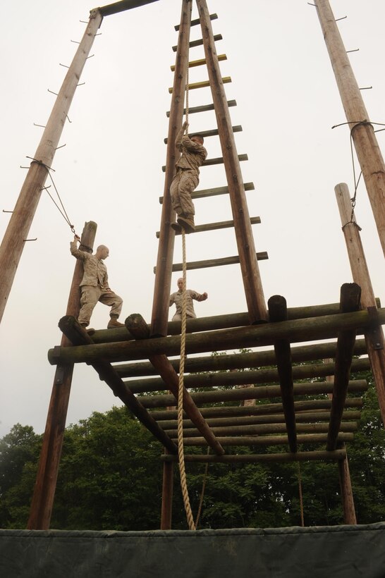 Marines navigate the A-frame, an event at the Confidence Course aboard Marine Corps Base Quantico on May 22, 2013. The course was used by Headquarters and Service Battalion as a company physical training exercise.