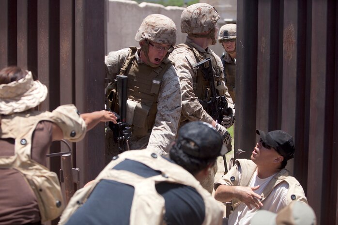 MARINE CORPS TRAINING AREA BELLOWS, Hawaii - Marines with Fox Company, 2nd Battalion, 3rd Marine Regiment conduct noncombatant evacuation operation training with role-players at Marine Corps Training Area Bellows military operations on urban terrain town, May 16. (U.S. Marine Corps photo by Lance Cpl. Suzanna Lapi)