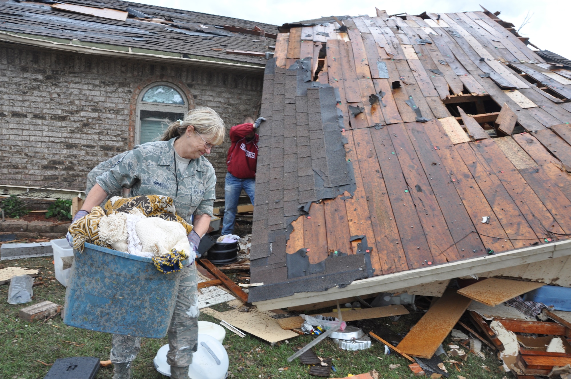 Air Force Master Sgt. Cherry Bina, Oklahoma Air National Guard, 137th Maintenance Group, recovers personal items from her own house in Moore, Okla., May 21, 2013. Her house was severely damaged after a devastating tornado killed dozens of people in Moore, Okla., May 20, 2013. (U.S. Air Force photo by Maj. Jon Quinlan)