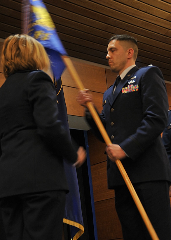 JOINT BASE ELMENDORF-RICHARDSON -- Lt. Col. Keolani "K O" Bailey accepts the 176 Logistics Readiness Squadron flag here May 18, 2013, from Col. Patty Wilbanks, commander of the 176 Misison Support Group, signifying he assumed command of the squadron. National Guard photo by Staff Sgt. N. Alicia Goldberger.