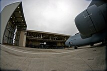 Troops from the 439th Maintenance Squadron prepare to tow a C-5 Galaxy into Westover's Regional Isochronal dock, May 22, 2013, to test the newly-constructed mobile tail enclosure. Crews broke ground April 1, 2012, for the $5 million MTE, is a moveable structure on rails that will protect maintenance troops from harsh New England weather. The MTE is the largest structure of its kind in the Air Force. (U.S. Air Force photo/W.C. Pope)