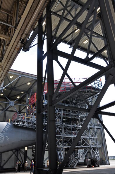 Troops from the 439th Maintenance Squadron prepare to tow a C-5 Galaxy into Westover's Regional Isochronal dock, May 22, 2013, to test the newly-constructed mobile tail enclosure. Crews broke ground April 1, 2012, for the $5 million MTE, is a moveable structure on rails that will protect maintenance troops from harsh New England weather. The MTE is the largest structure of its kind in the Air Force. (U.S. Air Force photo/SrA Kelly Galloway)