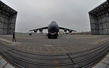 Troops from the 439th Maintenance Squadron prepare to tow a C-5 Galaxy into Westover's Regional Isochronal dock, May 22, 2013, to test the newly-constructed mobile tail enclosure. Crews broke ground April 1, 2012, for the $5 million MTE, is a moveable structure on rails that will protect maintenance troops from harsh New England weather. The MTE is the largest structure of its kind in the Air Force. (U.S. Air Force photo/SrA Kelly Galloway)