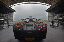 Troops from the 439th Maintenance Squadron prepare to tow a C-5 Galaxy into Westover's Regional Isochronal dock, May 22, 2013, to test the newly-constructed mobile tail enclosure. Crews broke ground April 1, 2012, for the $5 million MTE, is a moveable structure on rails that will protect maintenance troops from harsh New England weather. The MTE is the largest structure of its kind in the Air Force. (U.S. Air Force photo/SrA Kelly Galloway)