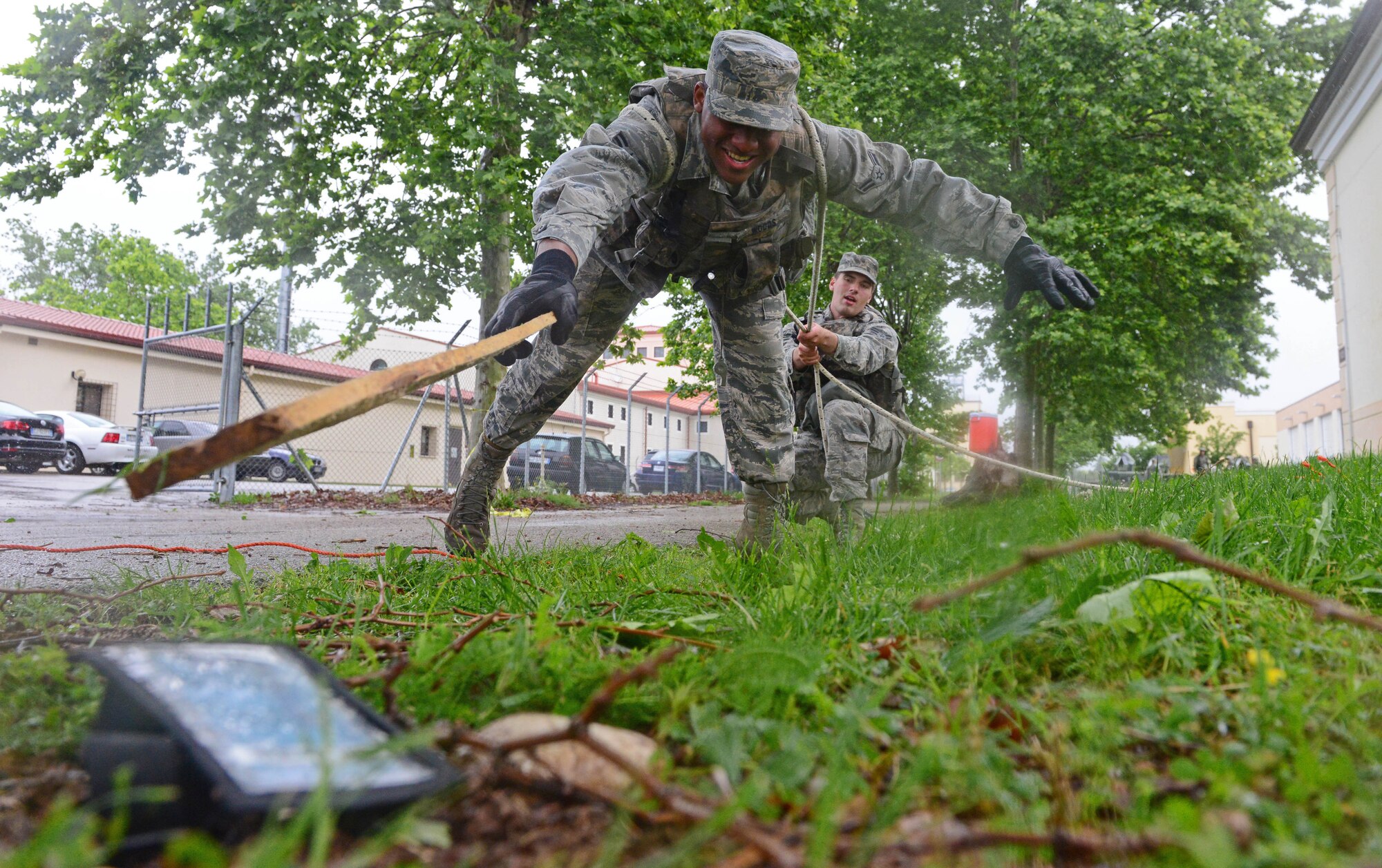 Airman 1st Class Harold Woods, 31st Security Forces Squadron security response team member, reaches for a pouch during a fire team challenge for National Police Week May 24, 2013, at Aviano Air Base, Italy. National Police Week at Aviano included a booth demonstration, 5K run, wreath display, fire team challenge and a military working dog retirement ceremony.  Police week is held annually to honor the contributions and sacrifices of law enforcement officials around the world. (U.S. Air Force photo/Airman 1st Class Matthew Lotz)