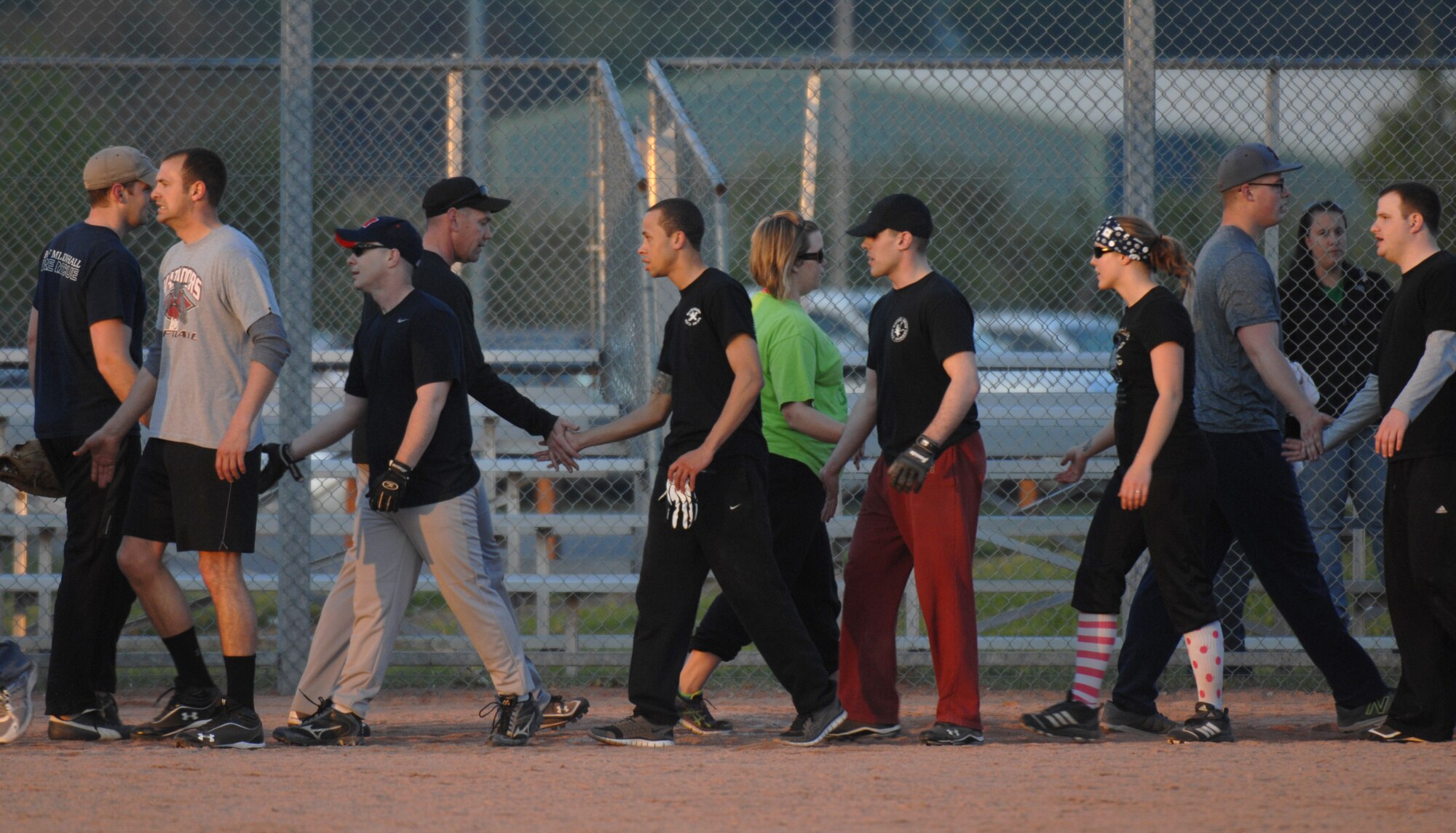 Team Mildenhall members congratulate each other following an intramural softball game between the 100th Communication Squadron and the 100th Civil Engineer Squadron May 22, 2013, at RAF Mildenhall, England. The 100th CS won the game 10 to 9. (U.S. Air Force photo by Airman 1st Class Dillon Johnston/Released)