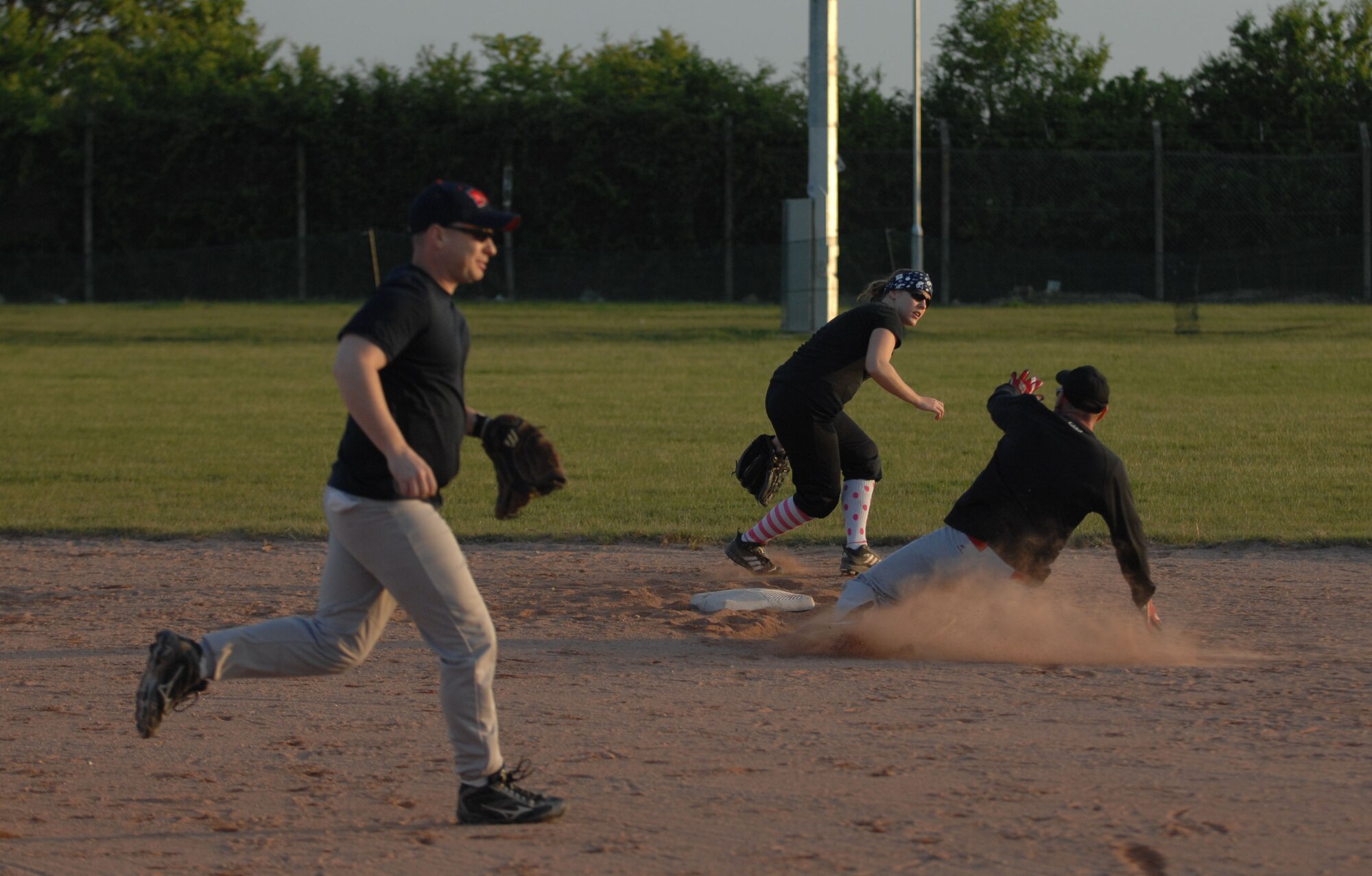 A 100th Civil Engineer Squadron team member slides into second base during an intramural softball game against the 100th Communication Squadron May 22, 2013, at RAF Mildenhall, England. The 100th CS won the game 10 to 9. (U.S. Air Force photo by Airman 1st Class Dillon Johnston/Released)