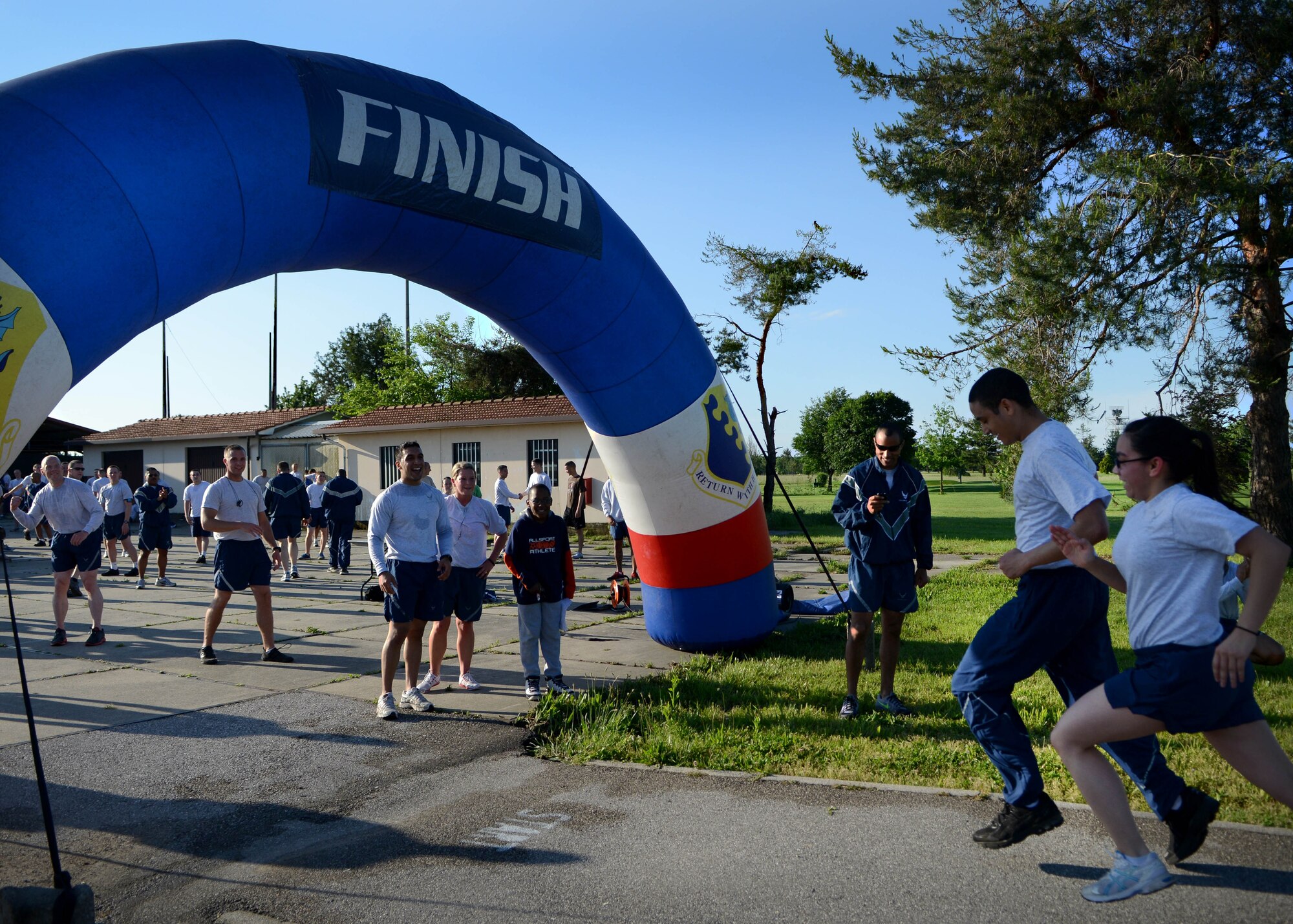 Airmen reach the finish line during a National Police Week 5K held May 21, 2013, at Aviano Air Base, Italy.  Police week is held annually to honor the contributions and sacrifices of law enforcement officials around the world. (U.S. Air Force photo/Staff Sgt. Evelyn Chavez)   