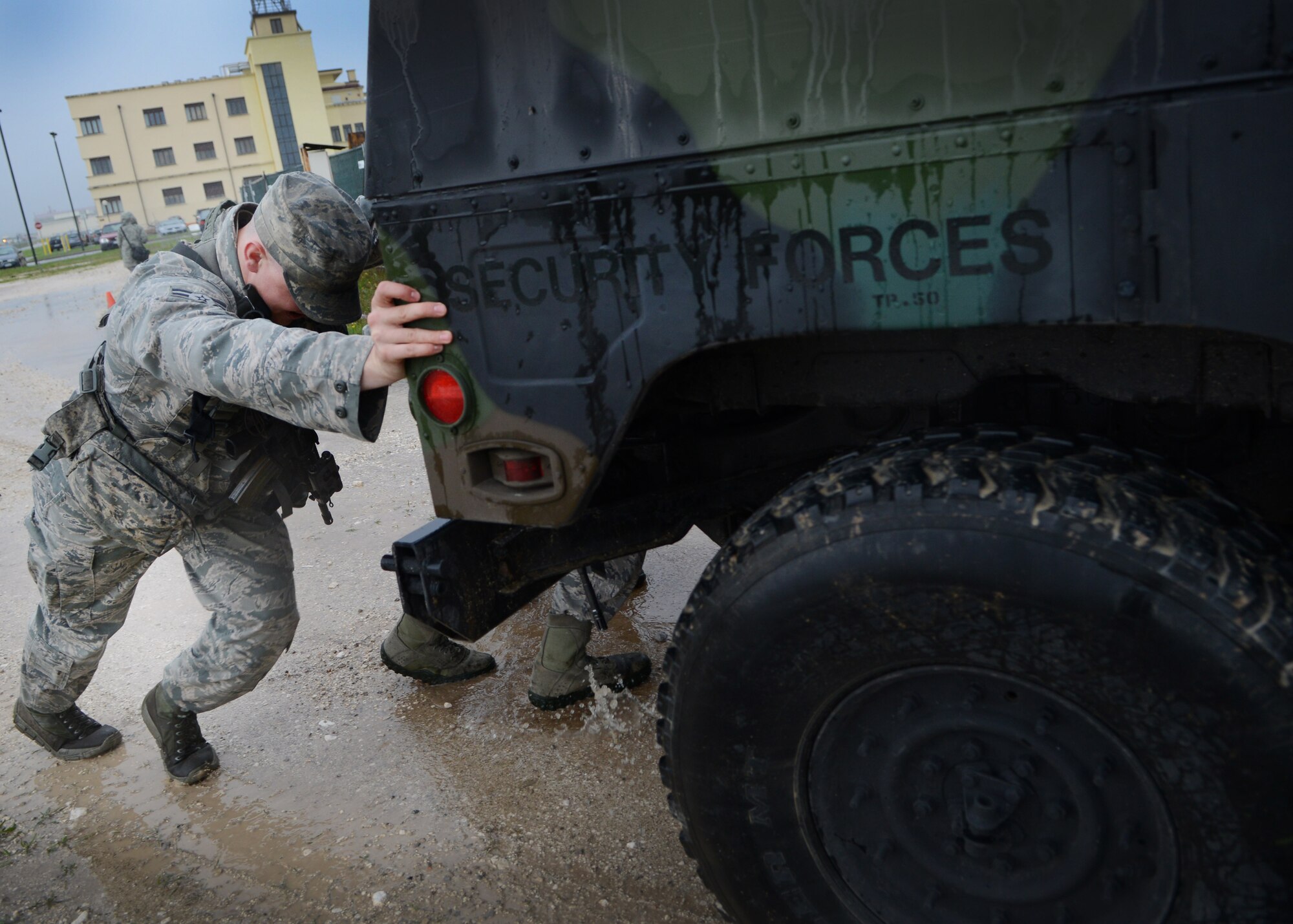 Senior Airman Brandon Andrews, 31st Security Forces Squadron security response team member, pushes a Humvee during a team challenge for National Police Week May 24, 2013, at Aviano Air Base, Italy. National Police Week at Aviano included a booth demonstration, 5K run, wreath display, fire team challenge and a military working dog retirement ceremony.  Police week is held annually to honor the contributions and sacrifices of law enforcement officials around the world.  (U.S. Air Force photo/Staff Sgt. Evelyn Chavez)
